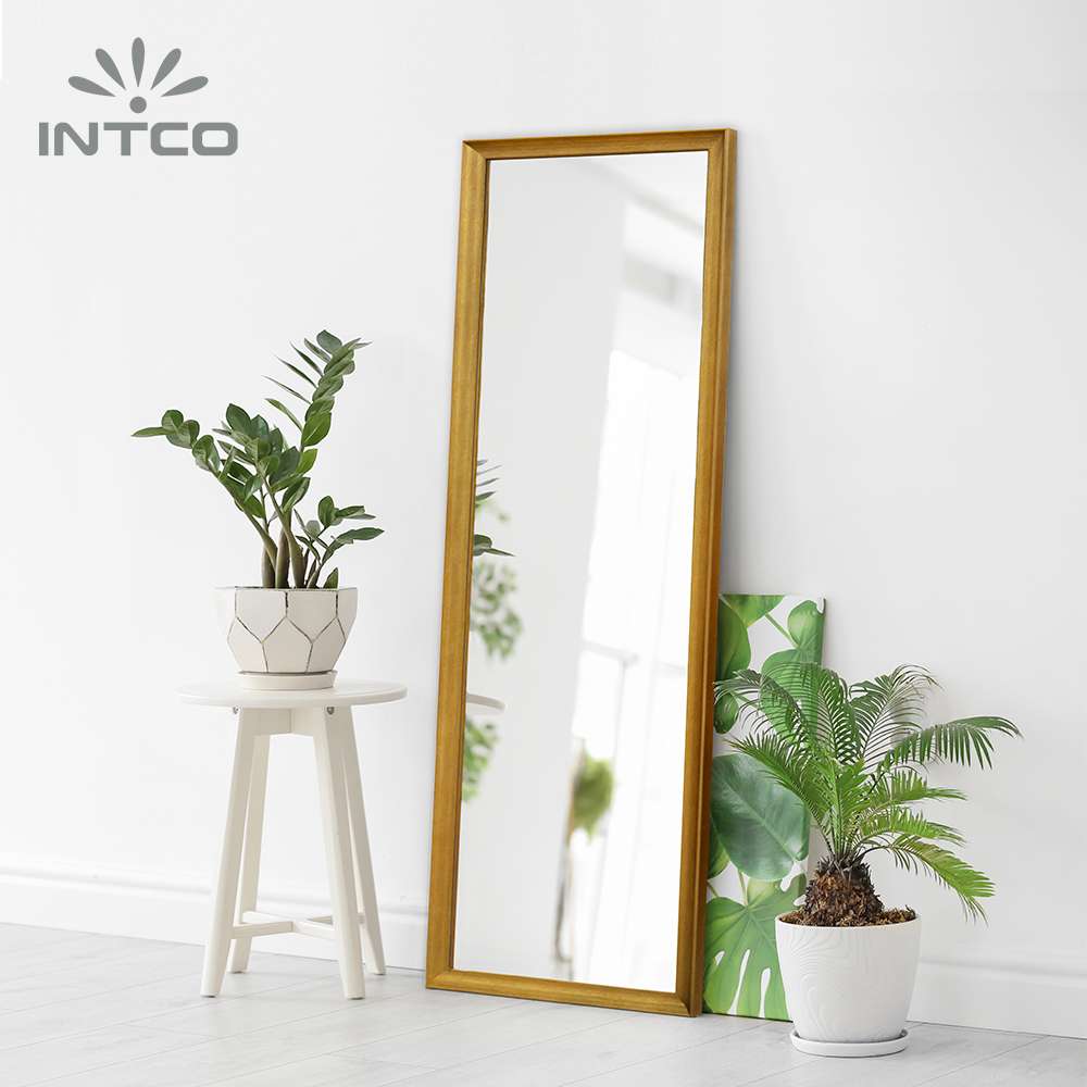 The sleek, decorative mirror frame creates a stunning room accent